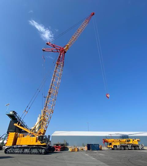 Side view of yellow HSC <a href='http://product.global-ce.com/crawler_crane/ 'target='_blank' style='color:blue;'>Crawler Crane</a> with boom and jib